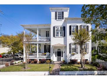 Three-story white house with black shutters, balconies, and ornate details at 162 Broad St # A, Charleston, SC 29401