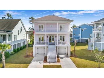 Two-story light purple house with white trim, double garage, and front porch at 2312 Bucktail Ct, Mount Pleasant, SC 29466