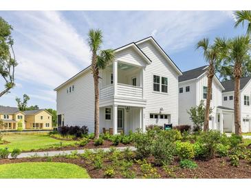 Two story home with white siding, landscaping and palm trees at 483 Queenview Ln, Charleston, SC 29414