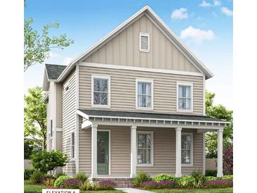 Two-story house with light beige siding, a green door, and a front porch at 357 Trailmore Ln, Summerville, SC 29486
