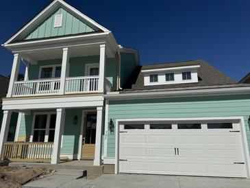 Two-story light teal home with white garage door at 364 Wappoo Trace Ln, Summerville, SC 29486