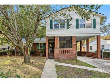 Two-story home with brick and siding exterior, screened porch and driveway at 103 Pandora Dr, Goose Creek, SC 29445