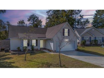 House exterior featuring a two-car garage and well-maintained lawn at 153 Penzance Blvd, Goose Creek, SC 29445