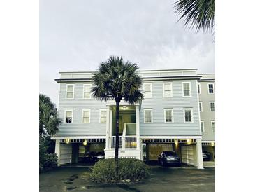 Two-story building with light blue siding and parking underneath at 1665 A Marsh Harbor Ln, Mount Pleasant, SC 29464