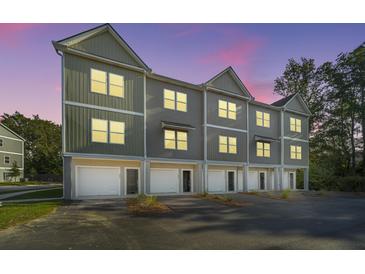 Townhouses with attached garages at dusk at 211 Cache Ct # 6, Charleston, SC 29414
