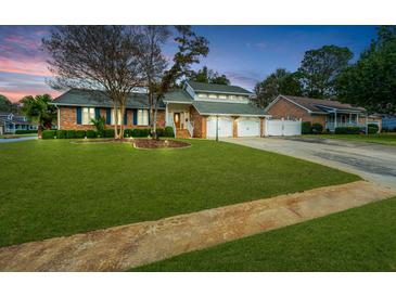 Brick house with a two-car garage and well-manicured lawn at 101 Westmoreland St, Summerville, SC 29483