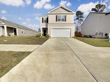 Tan two-story house with a white garage door at 498 Lake Ridge Blvd, Summerville, SC 29486