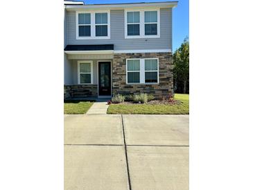 Two-story townhome with stone accents and a charming front porch at 7798 Park Gate Dr, North Charleston, SC 29418