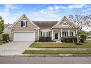 Tan house with white garage door and landscaping at 315 Oyster Bay Dr, Summerville, SC 29486