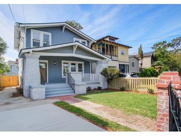 Charming two-story home with a welcoming front porch and brick walkway at 35 Cypress St, Charleston, SC 29403