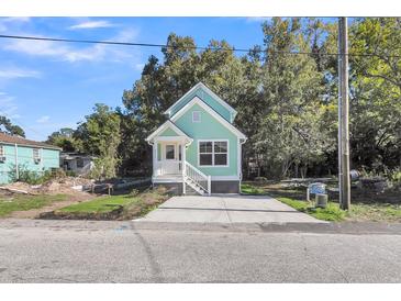 Charming light green house with white trim and a front porch at 2711 Henry St, North Charleston, SC 29405