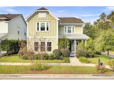 Charming two-story home with a light green exterior and landscaped yard at 211 Ilderton St, Summerville, SC 29483