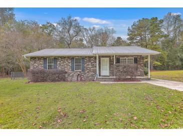 Brick ranch house with gray metal roof and small front porch at 313 Fairlawn Dr, Moncks Corner, SC 29461