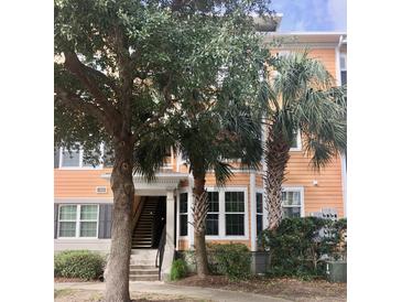 Attractive orange building with lush landscaping and palm trees at 1921 Telfair Way, Charleston, SC 29412