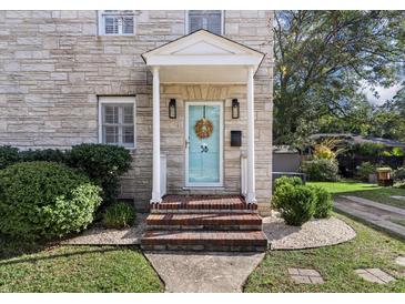 Charming stone front exterior with a welcoming porch and landscaping at 5 Chadwick Dr # 5-B, Charleston, SC 29407