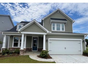 Two-story house with gray siding, white garage door, and stone accents at 137 Winding Grove Ln, Moncks Corner, SC 29461