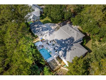 Aerial view of home showcasing pool, patio, and lush landscaping at 371 Live Palmetto Bluff, Mount Pleasant, SC 29464