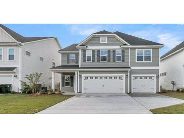 Two-story gray house with a two car garage and manicured lawn at 109 Seaton St, Summerville, SC 29486