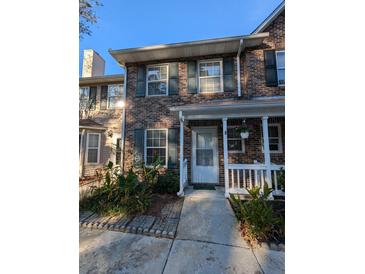 Brick townhouse with front porch and landscaping at 403 Reserve Way, Summerville, SC 29485
