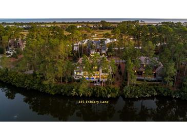 Luxury home nestled in a serene wooded setting with a pool and private dock at 415 Estuary Ln, Kiawah Island, SC 29455