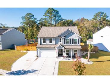 Two-story house with gray siding, white garage door, and landscaped yard at 2009 Elvington Rd, Johns Island, SC 29455