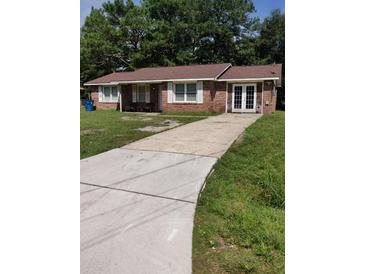 Brick ranch home with a long driveway and mature trees at 4450 Hardwood St, Ladson, SC 29456