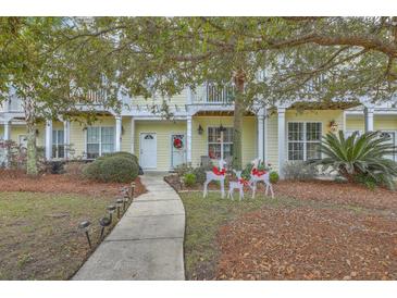 Inviting front entrance with landscaped walkway, charming porch, and festive decor at 1781 Brittlebush Ln, Johns Island,  29455