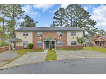 Brick triplex with spacious parking and mature trees at 7780 Wayfield Cir, North Charleston, SC 29418