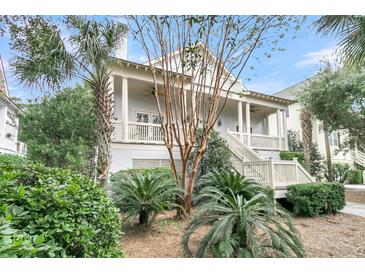 Two-story home with front porch and landscaped yard at 4028 Bridle Trail Dr, Seabrook Island, SC 29455