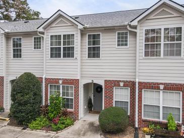 Two-story townhome with brick and siding, landscaping, and a welcoming front entrance at 945 E Estates Blvd # D, Charleston, SC 29414