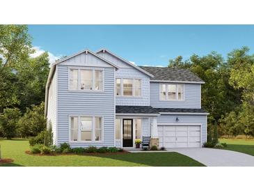 Two-story light blue house with gray roof, double garage, and front porch at 205 Denham St, Summerville, SC 29486