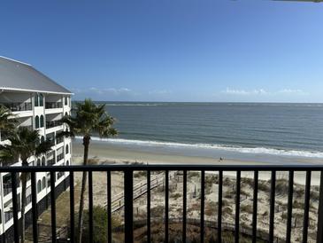 Breathtaking ocean view from balcony, showcasing beach and coastline at 9002 Palmetto (1/13 Share) Dr # 517, Isle of Palms, SC 29451