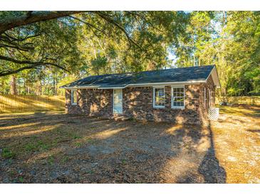 Brick ranch home with a large tree in the front yard and a fenced backyard at 110 Edgebrook Dr # 28, Summerville, SC 29486
