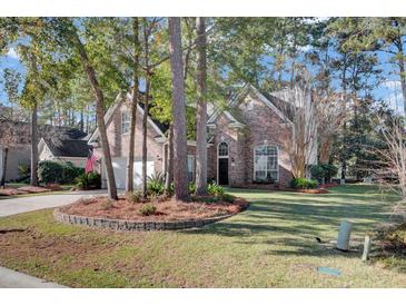 Brick home with landscaped lawn and two-car garage at 540 Pointe Of Oaks Rd, Summerville, SC 29485