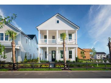 Two-story home with white siding, front porch, and landscaping at 1447 Clay Field Trl, Summerville, SC 29485