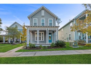 Charming two-story home with gray siding, a front porch, and well-manicured lawn at 313 Oakbend St, Summerville, SC 29486