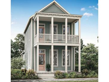 Two-story craftsman style home with a light green exterior, front porch, and balcony at 323 Trailmore Ln, Summerville, SC 29486