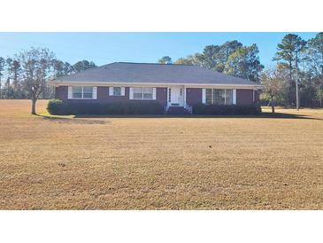 Brick ranch house with large yard at 388 E Main St, Harleyville, SC 29448