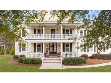 Two-story house with wraparound porch and landscaped yard at 1129 Plantation Overlook Dr, Moncks Corner, SC 29461