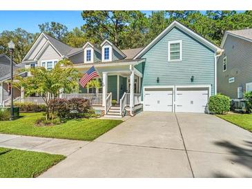 Two-story home with a charming front porch and attached two-car garage at 160 Ashley Bluffs Rd, Summerville, SC 29485