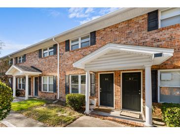 Brick building with two-unit entry, featuring covered porches and landscaping at 1820 Mepkin Rd # B6, Charleston, SC 29407