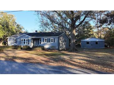 Charming gray house with a detached garage and mature trees at 412 Live Oak St, Walterboro, SC 29488