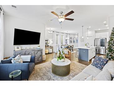 Open living room with sectional sofa, coffee table, and built-in shelving at 658 Blueway Ave, Summerville, SC 29486