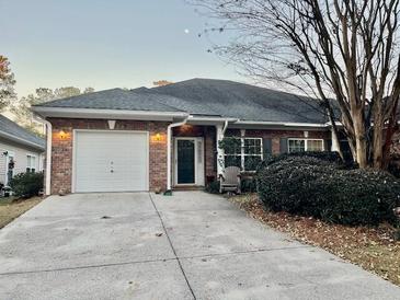 Brick ranch home with attached garage and landscaping at 127 Manning Ct, Summerville, SC 29485