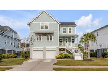 Two-story house with light green exterior, two-car garage, and landscaped lawn at 1475 Sheepshead Ln, Mount Pleasant, SC 29466