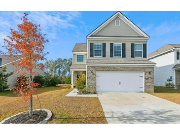 Two-story house with neutral siding, brick accents, and a two-car garage at 216 Daniels Creek Cir, Goose Creek, SC 29445