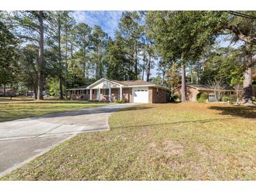 Brick ranch house with attached garage and large yard at 301 Corey Blvd, Summerville, SC 29483