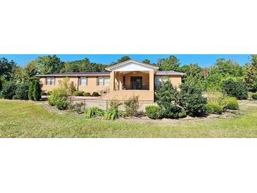 Ranch-style brick home with landscaped yard and fenced area at 3112 Santee River Rd, Saint Stephen, SC 29479