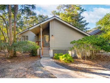 Charming one-story home with a landscaped yard and walkway at 456 Vetch Ct, Kiawah Island, SC 29455