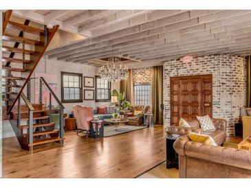 Spacious living room features hardwood floors, exposed beams, and comfortable seating at 65 Spring St, Charleston, SC 29403